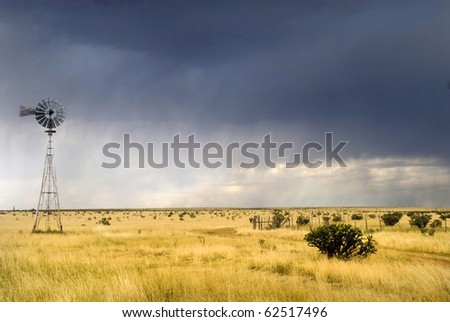 Windmill in a Texas field along Route 66 with a storm approaching