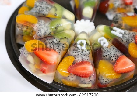 Close up to mix fruits gelatin cake for happy birthday celebration 