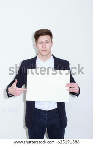 Happy smiling business man showing blank signboard, isolated over white background