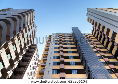 low angle view of the common modern condominium building with skyscrapers over blue sky, concept of economics, construction, modern city life, accommodation etc. Royalty-Free Stock Photo #625206104