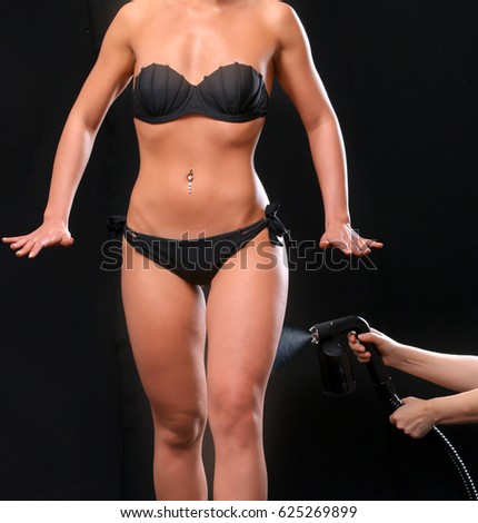 Woman body paint with airbrush in professional beauty salon Royalty-Free Stock Photo #625269899