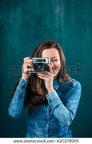 Beautiful young girl with photo camera