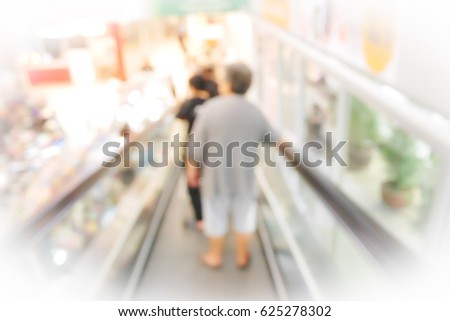 Picture blurred abstract background of people use escalator