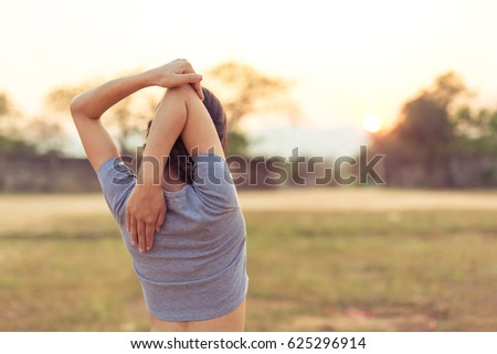 Beautiful fit young woman public park fitness stretching