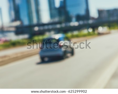 Blurred cityscape with car and modern buildings