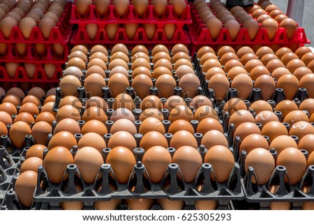 The row or the stack of eggs at the pick up back during transportation at the market.