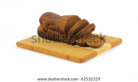 Three thick slices of pumpernickel bread on a cutting board.