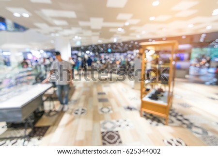 Abstract blur beautiful modern luxury shopping mall and retails store interior for background. color filter people walking in shopping mall. department store indoor. shopping mall.vacation weekend day
