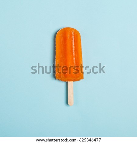 Tasty and refreshing popsicles on blue background