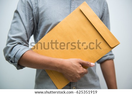 Man hand holding brown envelope on white background