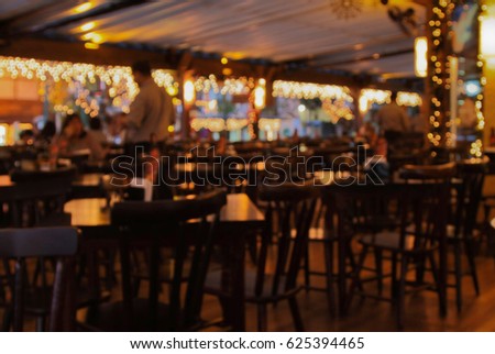 Defocused or blurred image of Cafe or restaurant in night time with bokeh. 