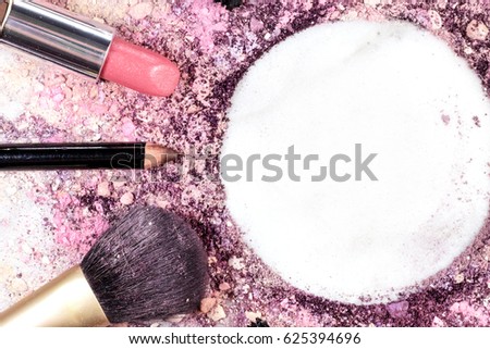 Makeup brush, lipstick and pencil on a white background, with traces of powder and blush on it. A horizontal template for a makeup artist's business card or flyer design, with copy space