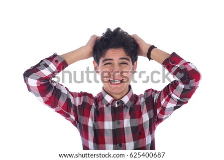 Disappointed sad  teenage boy crying and holding his hair, teenager looking side and wearing red shirt, isolated white back ground