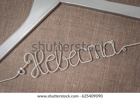 Bride hanger with inscription "Bride" in Russian language. Handmade clothes hanger. Close up.