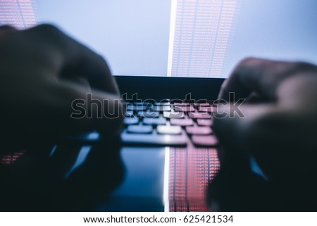 Russian hacker hacking the server in the dark Royalty-Free Stock Photo #625421534