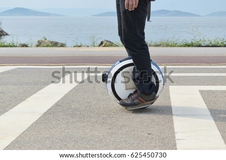 Electric unicycle. a man rides on mono wheel Royalty-Free Stock Photo #625450730