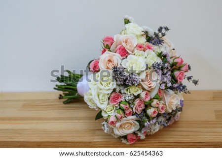 Wedding bouquet with colorful flowers at wooden shelf