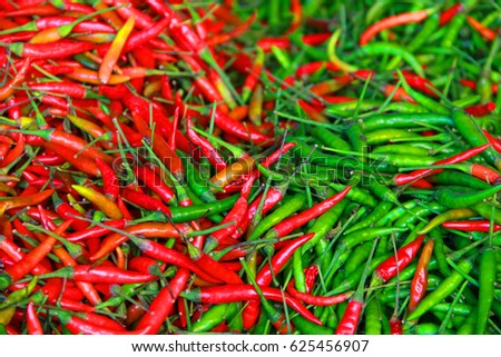 Close-up of some red and green chillies mixed.Blur.