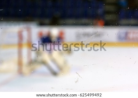 Hockey goalkeeper behind the plexiglas on ice hockey stadium during professional championship in Slovakia - winter sport concept photo