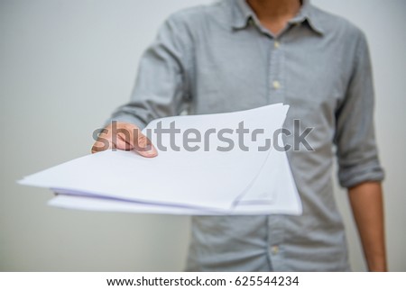Business concept. Businessman holding white sheet of paper