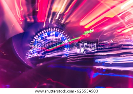 Car dashboard with speedometer on a blurred background. Speed lights, allusion to Speed.