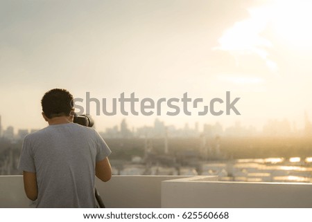Back side of Photographer with cityscape view.