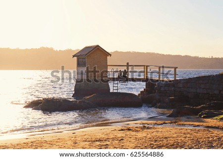 A couple enjoying the sunset at Camp Cove, Sydney, Australia