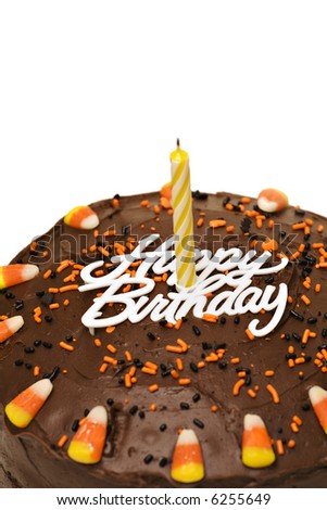 Fall chocolate birthday cake with candle, sprinkles and candy corn.