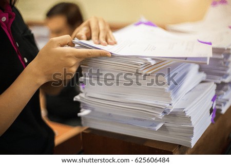 Pile of unfinished documents on office desk with business office  background