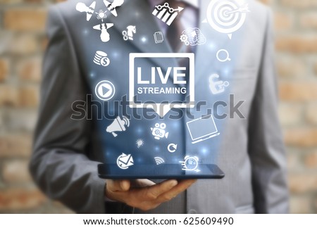 Live streaming social media web network concept. Man offers tablet computer with icon bubble live streaming on virtual screen. Broadcast online technology stream video and music. Internet marketing.