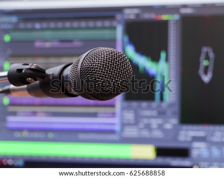 Microphone on the background of the computer monitor. Home recording Studio. Close-up. The focus in the foreground. Blurred background. Software for recording and editing sounds. Postproduction