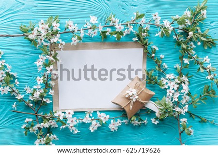 spring flower and greeting card on a blue wooden background.mothers day
 Royalty-Free Stock Photo #625719626