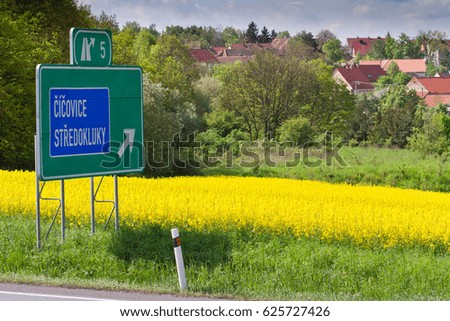 raps field with highway exit sign, Stredokluky, Czech republic