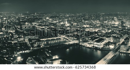 London aerial view panorama at night with urban architectures and bridges.