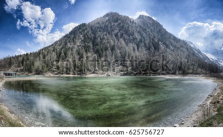 Lake of the Fairies with mountain and blue sky in background near little village of Macugnaga