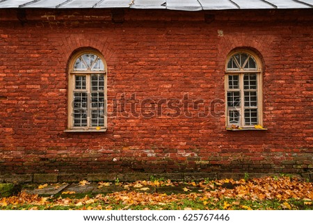 Texture of red bricks with arched windows. Wall of an old house.