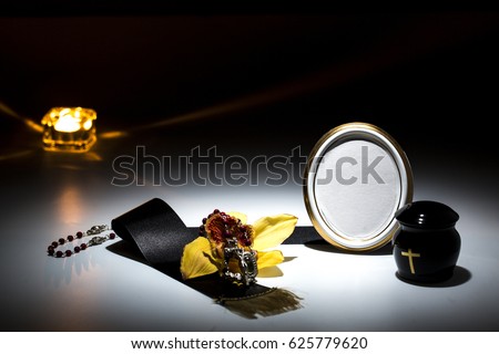 mourning frame with black urn and black tape, flower, yellow orchid, candle, for sympathy card on background