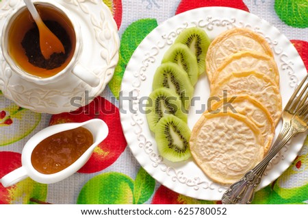 Vegan pancakes with kiwi tea and jam  