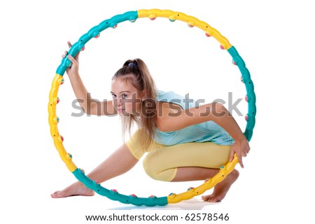 Young woman in sports clothing is sitting and holding a fitness hoop.