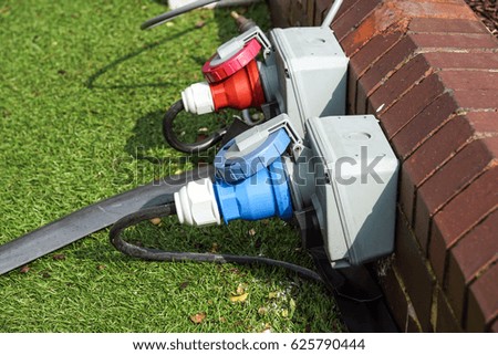 An electric socket timer with cord attached. This one is used outdoors in damp weather which might present a safety issue. Water drops on casing