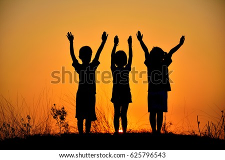 Silhouette of three children friendship at sunset.People friendship silhouette.