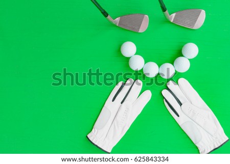 Golf concept : glove, golf balls, golf clubs on wooden table. Flat lay with copy space.