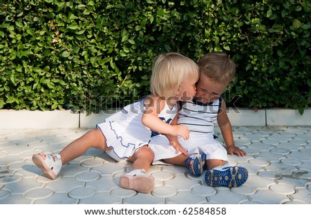 Baby girl kissing baby boy