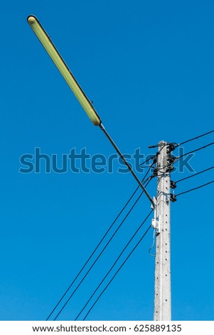 Electricity post with blue sky.