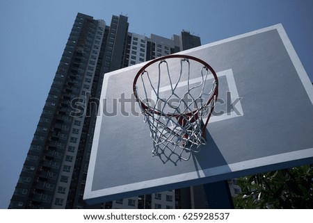 Basketball hoop and building under blue sky
