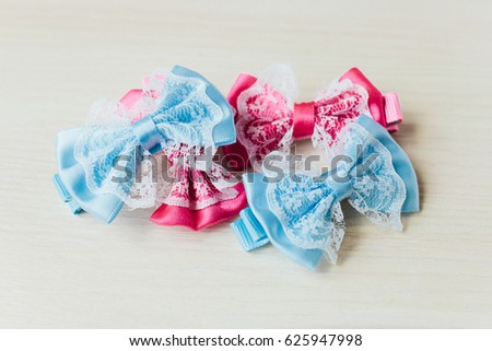 Barrette bow. Hairpin Butterfly. Blue and pink hair accessories. White wooden background
 Royalty-Free Stock Photo #625947998