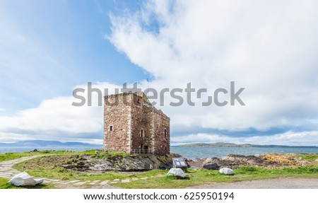 Portencross Castle on a clear day with blue sky's and the Cmbrae's and Arran in the back ground.