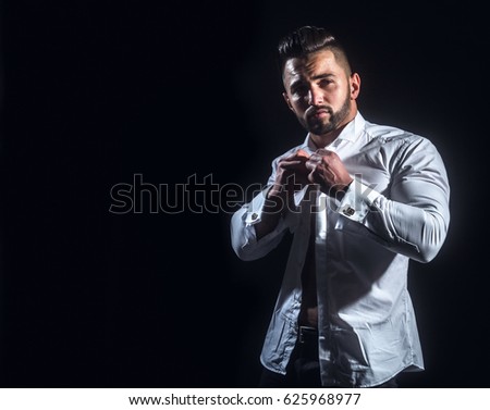 Businessman thinks in the morning. White man in white shirt on black background. Young attractive businessman thinking before work. Dream of success