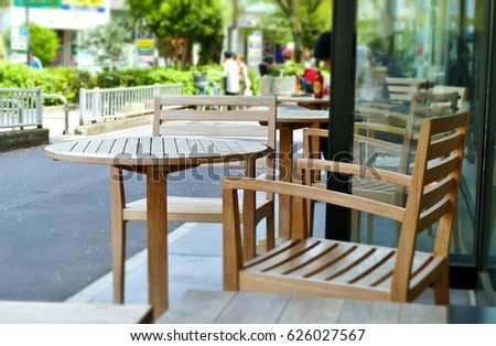 set of wooden table and chair at the coffee shop at the small road