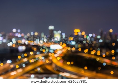 Blurred bokeh light highway intersection aerial view, abstract background